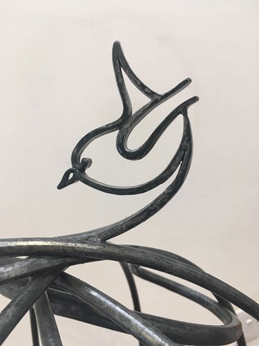 hand forged Wren on the top of a bespoke made bird table